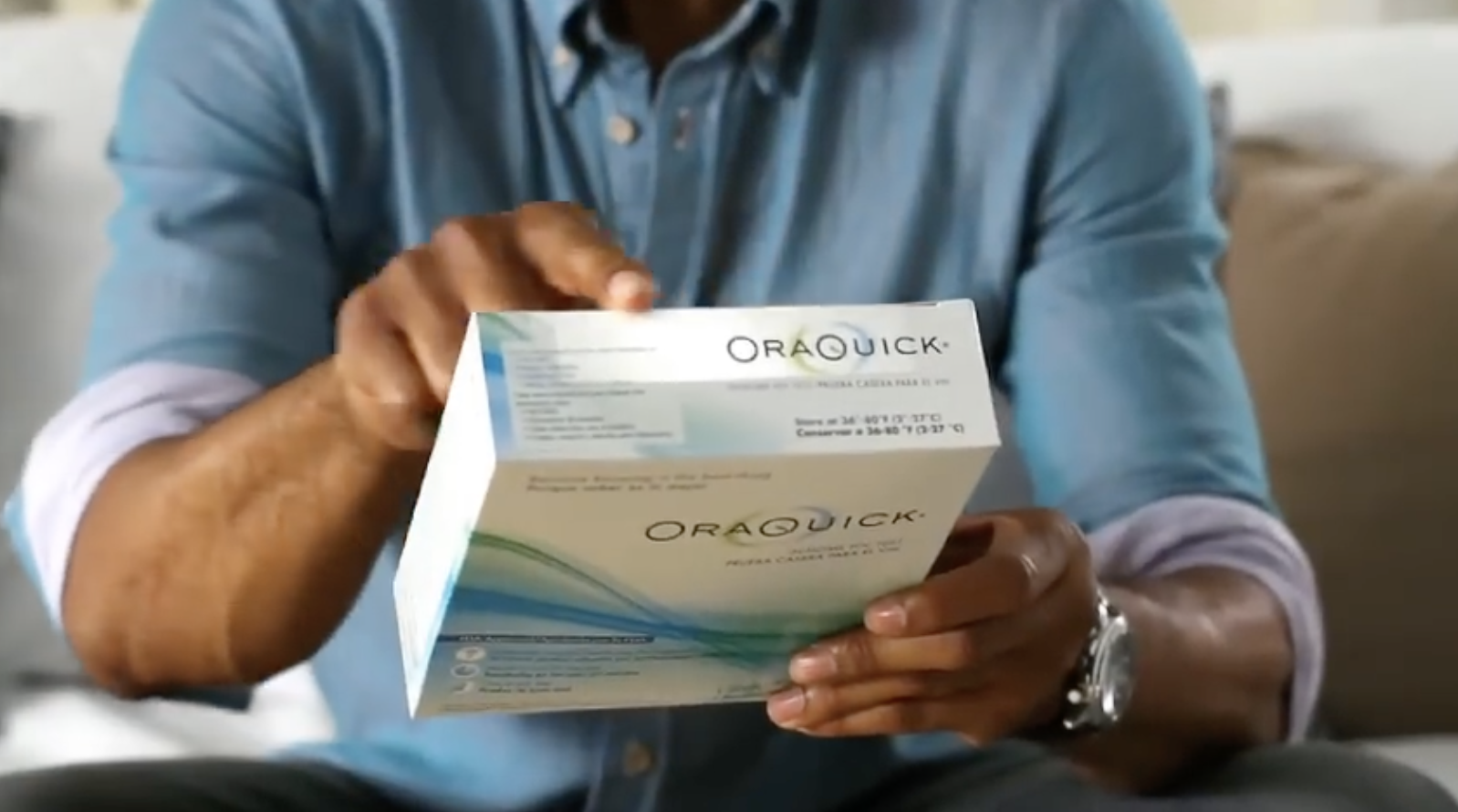Person holding an at-home OraQuick HIV test