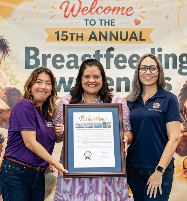 Three DOH-Miami-Dade employees hold a proclamation